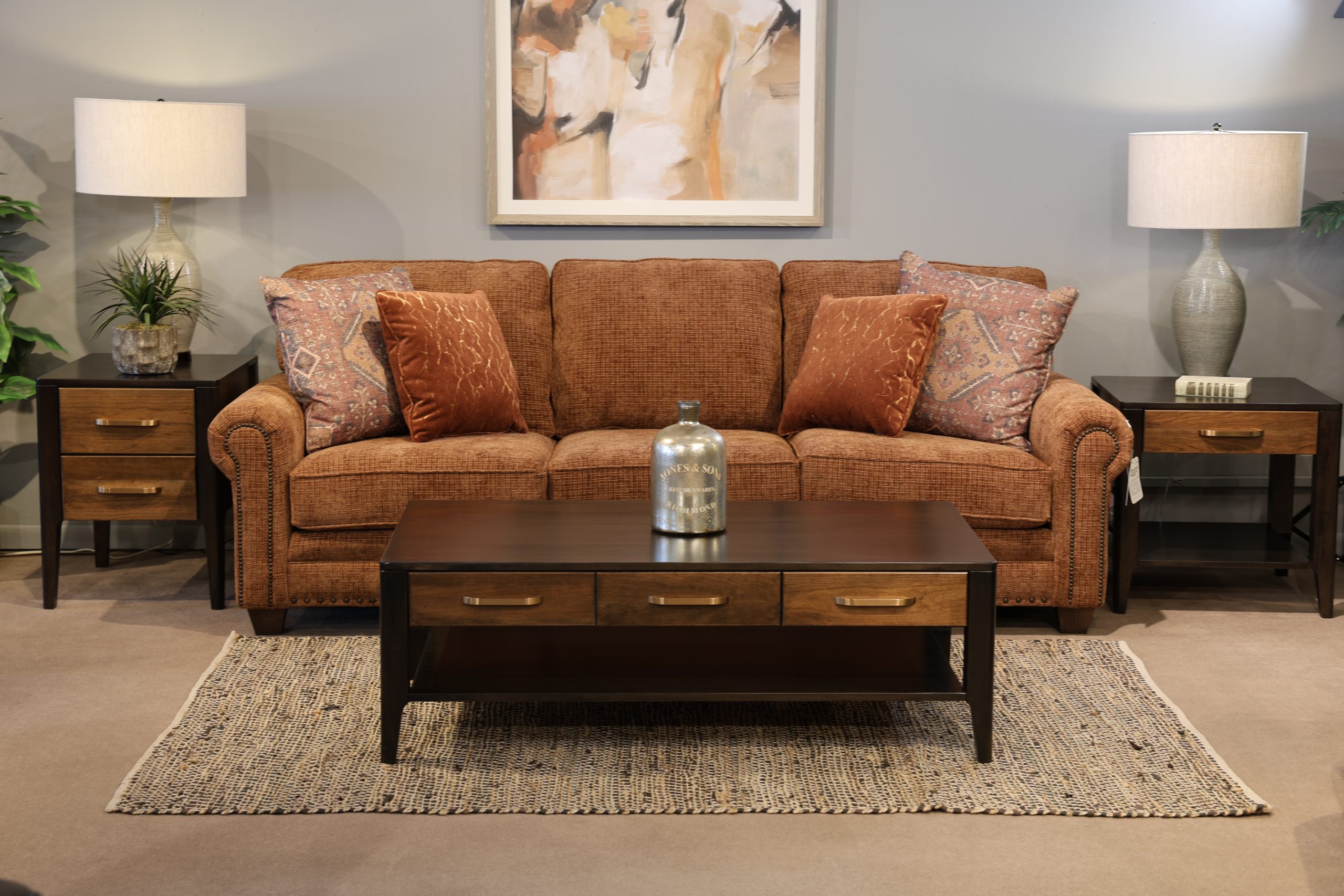 woman standing in front of orange Smith Brothers couch